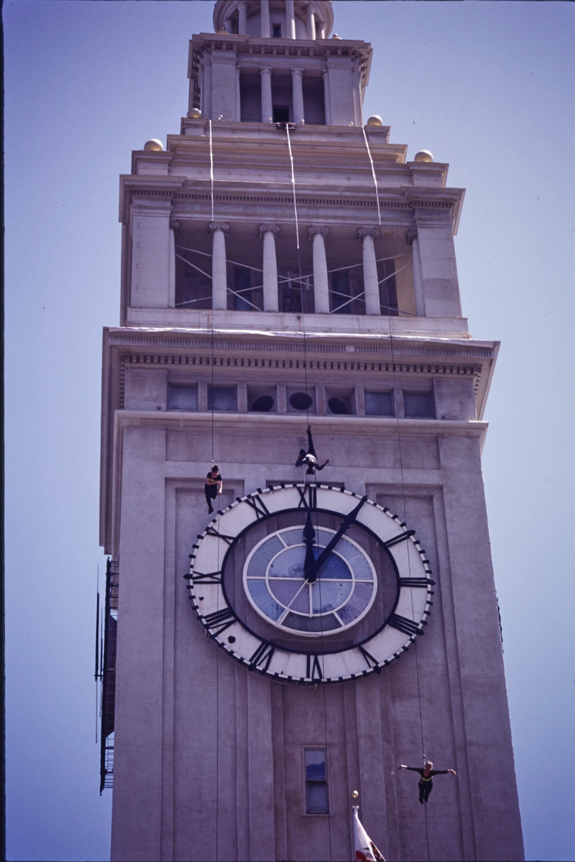 Dancers use harnesses to suspend themselves atop the clocktower at San Francisco's Ferry Building. 